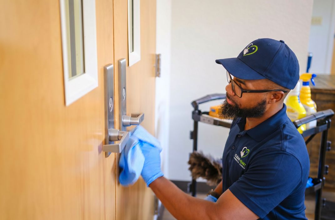 Clean Heart team member disinfecting a high-touch door handle